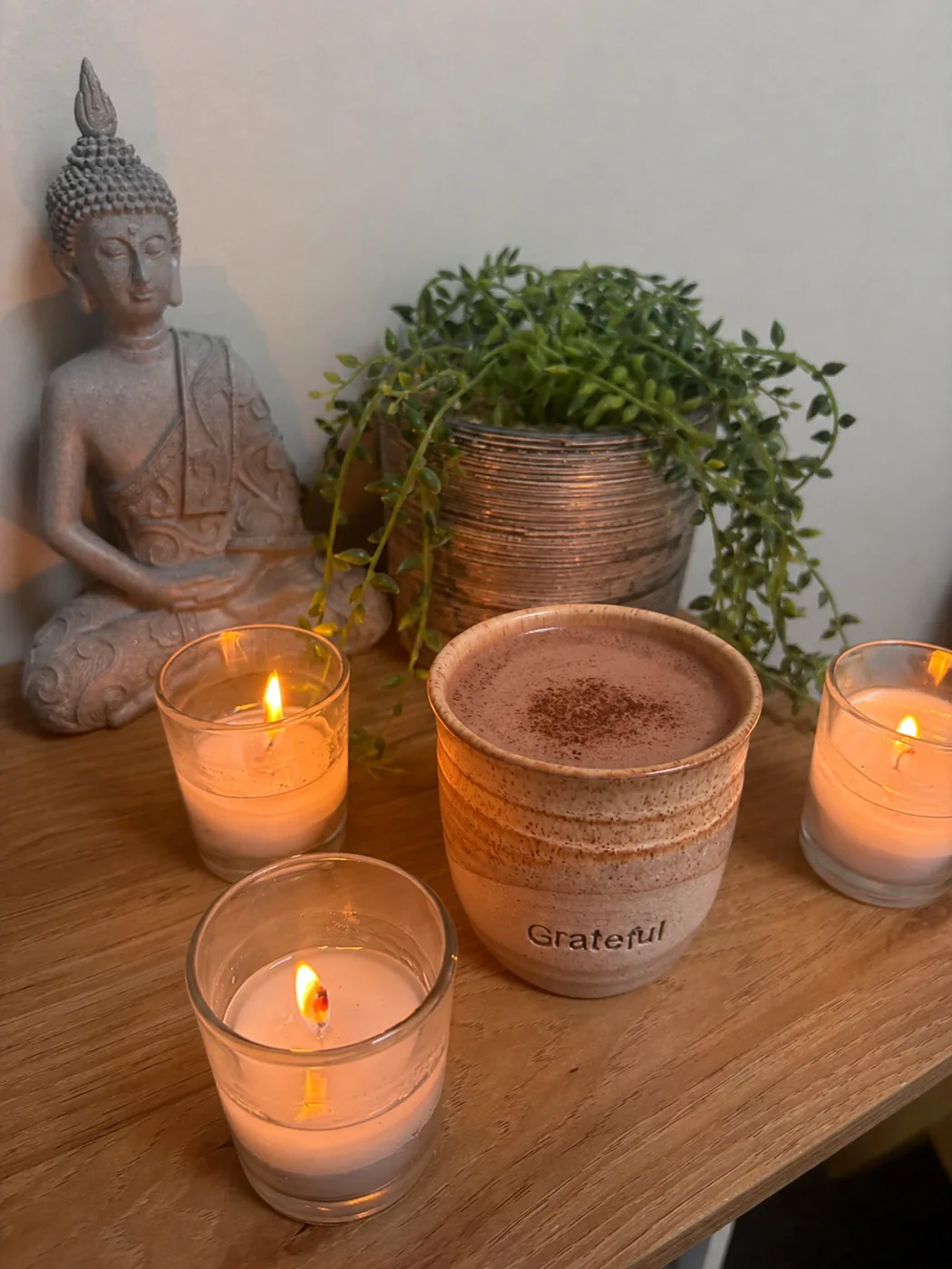 A warm cup of ceremonial cacao by candlelight at Pause by Mel