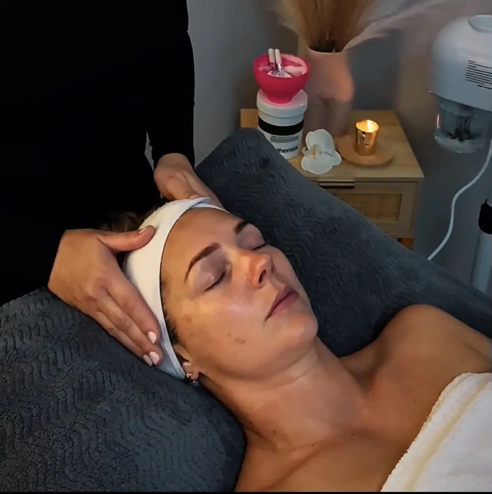 A client cradled and relaxed on the treatment bed at Pause by Mel