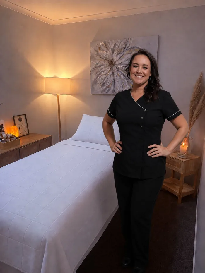 Mel standing beside the treatment bed in her Papamoa studio